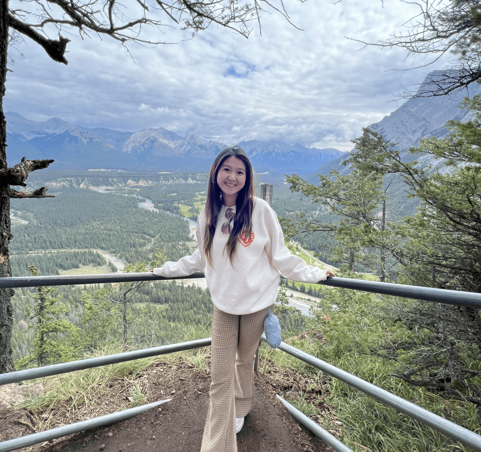 Photo of Gina outdoors overlooking a mountain valley